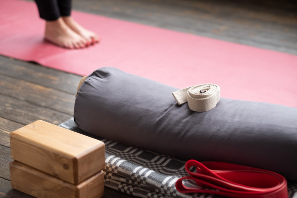 various yoga equipment on wooden floor